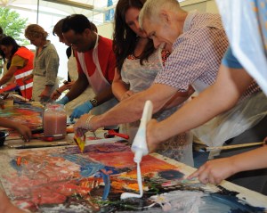Participants and volunteers inking up the plates.